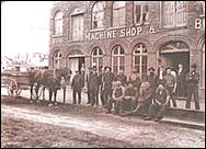 A group of people posing for a photo next to a horse and carriage

Description automatically generated with medium confidence