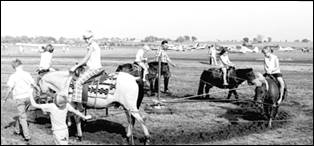 A group of men standing in a field

Description automatically generated