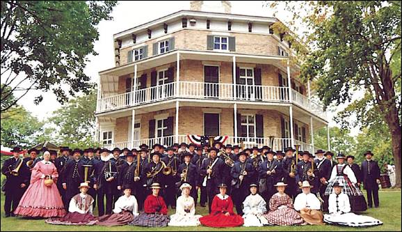 A group of people in front of a house

Description automatically generated with medium confidence