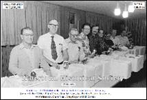 A group of men sitting at a table

Description automatically generated with low confidence