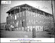 A picture containing text, old, apartment building, tower

Description automatically generated