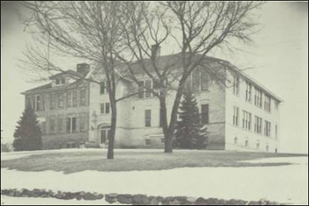 A large building with a tree in front of it

Description automatically generated with low confidence